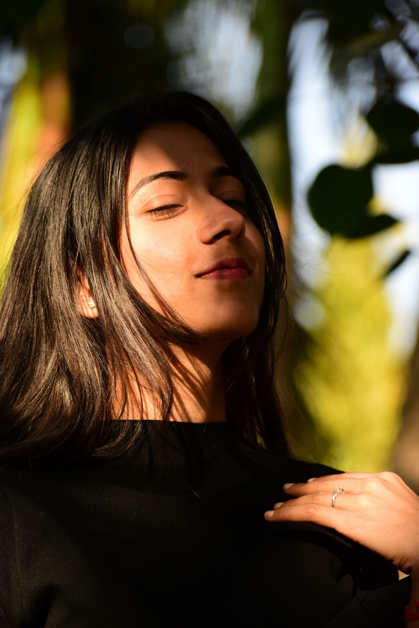 Woman with long dark hair in warm evening light