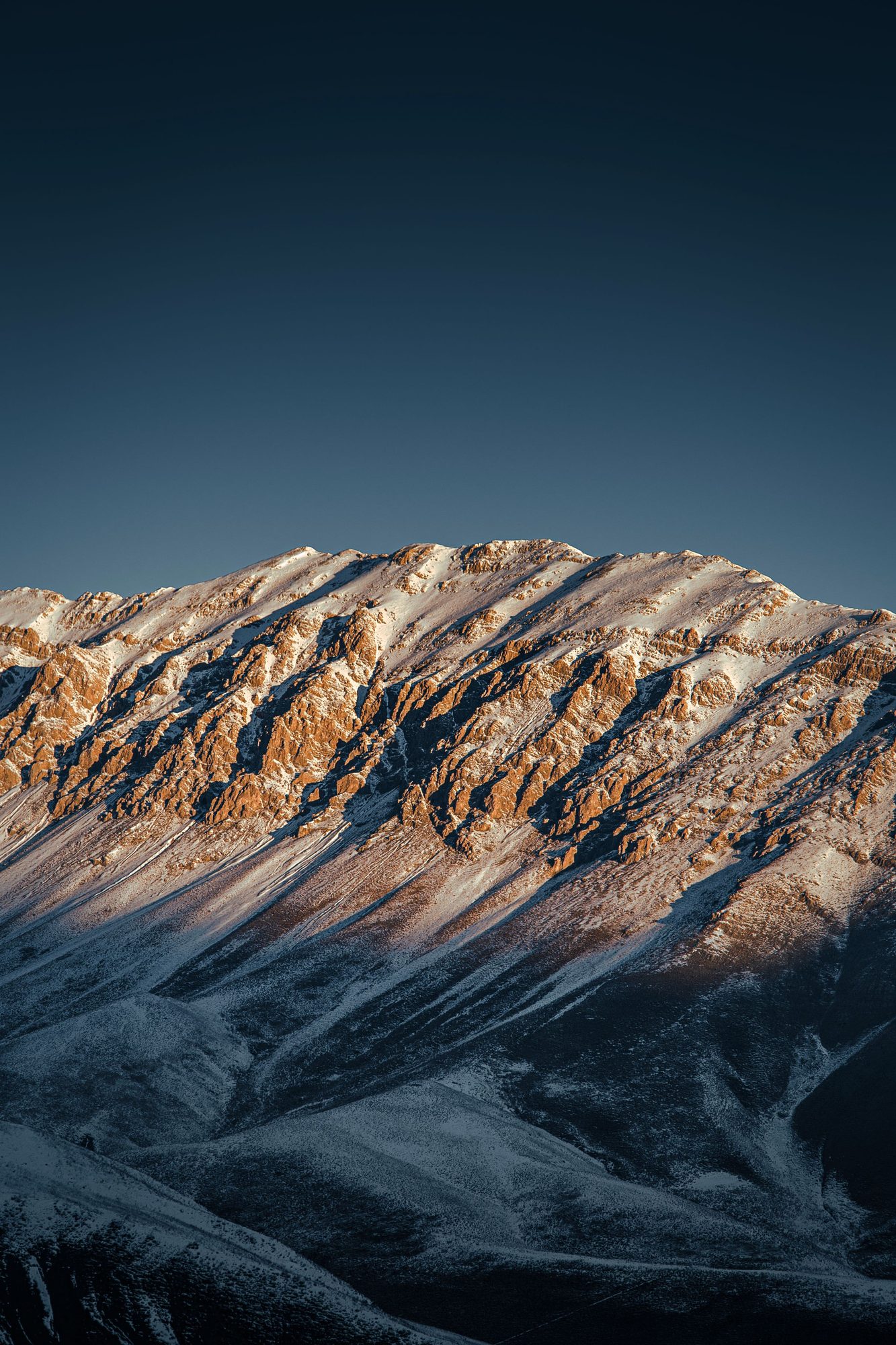 Snow capped peaks at dusk